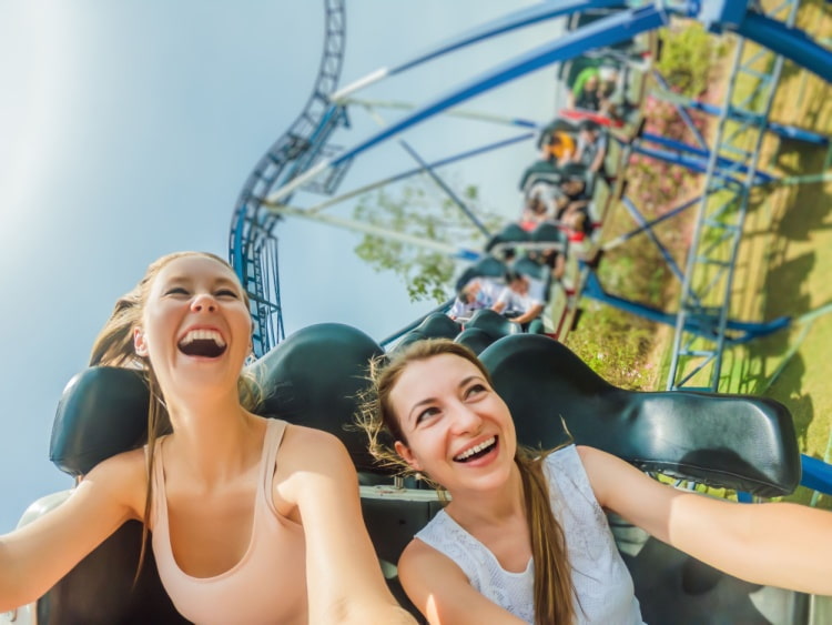 two students ride on a roller coaster