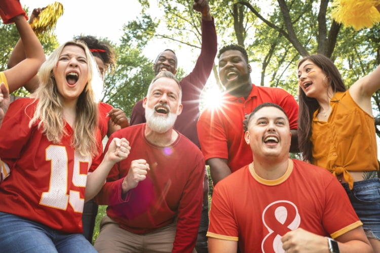 excited sports fans celebrate before a game
