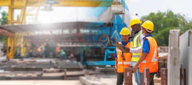 construction workers discuss project plans at a worksite